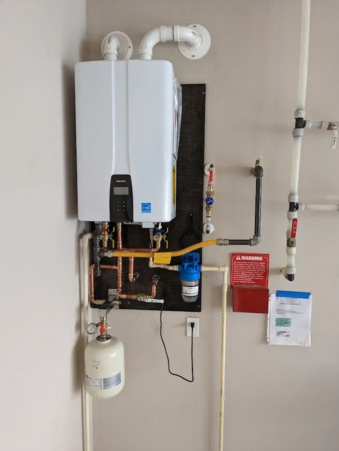 Professional plumber installing copper piping in a Eastchester home